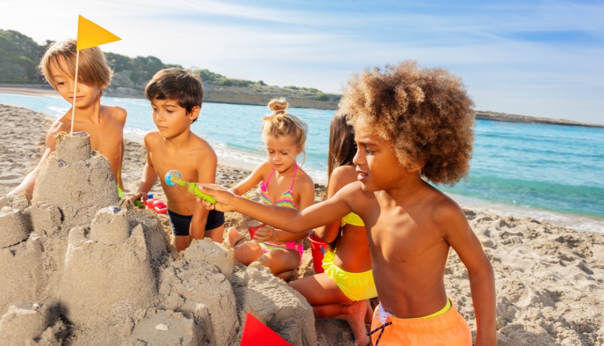 Kids Creating Sandcastle on the Beach in Summer Image by Sergey Novikov