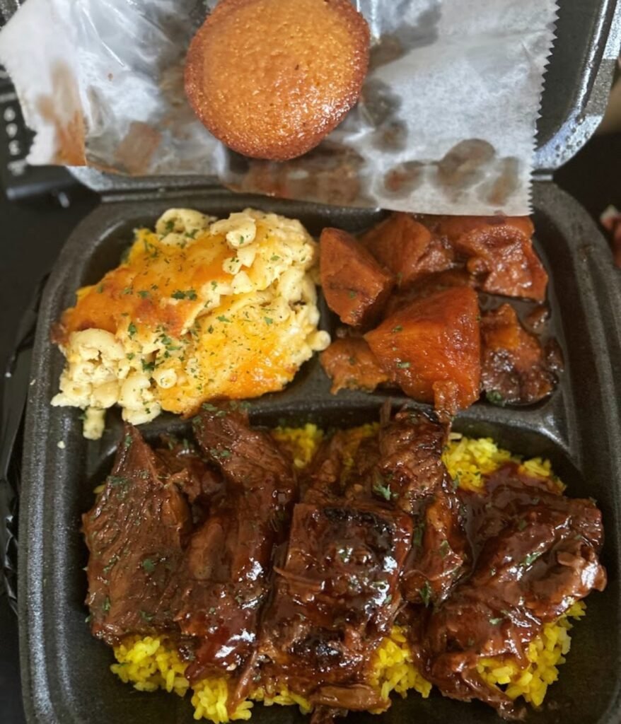 Beef short ribs with mac, yams and corn muffins at Jannah's Soul Food in Philadelphia, PA Image by Jatyra P